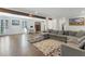 An open-concept living room featuring hardwood floors, a large sectional sofa, and ample natural light at 4970 Lakeland Woods Ct, Atlanta, GA 30338