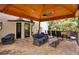 A covered patio area with comfortable seating and a dining table for outdoor relaxation and dining at 4970 Lakeland Woods Ct, Atlanta, GA 30338