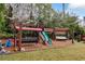 A backyard playground featuring swings, a slide, and climbing structures for outdoor fun at 4970 Lakeland Woods Ct, Atlanta, GA 30338