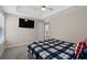 Bedroom featuring a tray ceiling, with a ceiling fan and a large television at 7178 Cavender Sw Dr, Atlanta, GA 30331