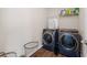 Bright laundry room featuring modern washer and dryer with wooden-style flooring at 7178 Cavender Sw Dr, Atlanta, GA 30331