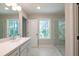 Inviting bathroom showcases double sinks, marble floors, and a glass-enclosed shower at 1624 Ruskin Way, Marietta, GA 30062