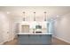 Modern kitchen with white cabinets, stainless steel appliances, pendant lights, and a gray island at 1624 Ruskin Way, Marietta, GA 30062