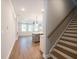 Open concept living area with hardwood floors, staircase, and a view of the kitchen island at 1624 Ruskin Way, Marietta, GA 30062