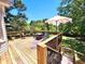 Spacious wooden back deck offers ample seating with wooded views, perfect for entertaining at 345 Lambeth Dr, Hiram, GA 30141