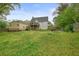 Expansive backyard features a detached garage, two-story house with a deck, and a partial wooden fence at 345 Lambeth Dr, Hiram, GA 30141
