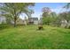 Large, grassy backyard with mature trees, shed, wood fence, and a two-story home with a deck at 345 Lambeth Dr, Hiram, GA 30141