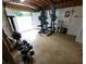 Well-equipped basement gym area featuring free weights, weight rack, exercise bike and natural light from walk-out door at 345 Lambeth Dr, Hiram, GA 30141