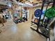Finished basement area with gym and storage; features work-out bench, free weights, exercise bike and storage shelving at 345 Lambeth Dr, Hiram, GA 30141