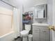 Functional bathroom with a shower-tub combo, storage shelves, and a classic vanity at 345 Lambeth Dr, Hiram, GA 30141