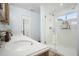 Bright bathroom with double sinks, tile floor, and glass-enclosed shower at 345 Lambeth Dr, Hiram, GA 30141