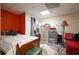 Large bedroom featuring a bed, multiple storage areas, and a bright orange wall at 345 Lambeth Dr, Hiram, GA 30141