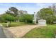 Suburban home features a concrete driveway, detached garage, green lawn and mature trees at 345 Lambeth Dr, Hiram, GA 30141