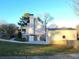 Rear view of a home with a detached garage, and a spacious yard, creating a private oasis at 345 Lambeth Dr, Hiram, GA 30141
