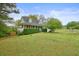Charming home with well-manicured lawn and mature landscaping, featuring red shutters and a covered front porch at 345 Lambeth Dr, Hiram, GA 30141