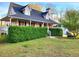 Charming home boasts manicured lawn, mature landscaping, and inviting front porch at 345 Lambeth Dr, Hiram, GA 30141