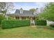 Charming two-story home with a covered porch, manicured hedges, red shutters, and a well-kept front lawn at 345 Lambeth Dr, Hiram, GA 30141