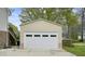 A large, detached garage with a white door and neutral siding, offers ample parking at 345 Lambeth Dr, Hiram, GA 30141