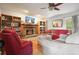Cozy living room with hardwood floors, brick fireplace, and built-in bookshelves at 345 Lambeth Dr, Hiram, GA 30141