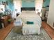 A cozy main bedroom with turquoise walls, wood floors, and comfortable furnishings at 345 Lambeth Dr, Hiram, GA 30141