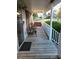 Inviting covered porch with a swing, seating, and wood floors, perfect for relaxing outdoors at 345 Lambeth Dr, Hiram, GA 30141