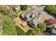 Birds eye shot showcases the home with a deck and landscaped backyard and surrounding trees at 5 Coventry Close, Avondale Estates, GA 30002