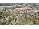 Lush aerial view of residential homes with tree coverage, nearby businesses, and construction zone creating a dynamic landscape at 5 Coventry Close, Avondale Estates, GA 30002