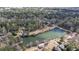 Aerial view of a tranquil lake surrounded by a vibrant community with tree-lined streets at 5 Coventry Close, Avondale Estates, GA 30002