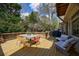 Backyard deck with dining table and seating arrangements, creating an inviting outdoor space at 5 Coventry Close, Avondale Estates, GA 30002