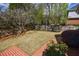 Well-maintained backyard featuring mature trees and manicured lawn at 5 Coventry Close, Avondale Estates, GA 30002