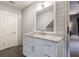 Bathroom featuring white vanity with marble countertop, shiplap walls, and gray tile flooring at 5 Coventry Close, Avondale Estates, GA 30002