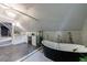 Elegant bathroom featuring a black soaking tub, glass partition, and dual vanity with marble countertops at 5 Coventry Close, Avondale Estates, GA 30002