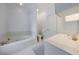 Bright bathroom features a jacuzzi tub with tile surround, and white cabinets at 5 Coventry Close, Avondale Estates, GA 30002