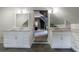 Bright bathroom with dual vanities, marble countertops, white cabinetry, and shiplap walls at 5 Coventry Close, Avondale Estates, GA 30002