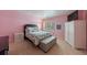 Pretty bedroom featuring a queen bed, matching nightstand, ottoman, large closet, and carpeted flooring at 5 Coventry Close, Avondale Estates, GA 30002