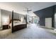 Bright bedroom featuring four-poster bed, chandelier, desk, and lots of natural light at 5 Coventry Close, Avondale Estates, GA 30002