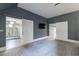 Large bedroom with patterned floors, flat-screen TV, and doorways to other rooms at 5 Coventry Close, Avondale Estates, GA 30002