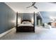 Spacious bedroom with four-poster bed, ceiling fan, and neutral patterned carpet at 5 Coventry Close, Avondale Estates, GA 30002