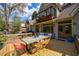 Spacious deck with modern outdoor dining set and access to a balcony and home interior at 5 Coventry Close, Avondale Estates, GA 30002