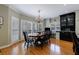 Bright dining room featuring hardwood floors, a chandelier, and large windows with plantation shutters at 5 Coventry Close, Avondale Estates, GA 30002