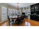 Elegant dining area featuring a chandelier, large windows with plantation shutters, and hardwood floors at 5 Coventry Close, Avondale Estates, GA 30002
