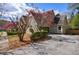 Attractive home showcasing a brick facade, well-kept landscaping, and a driveway leading to a garage at 5 Coventry Close, Avondale Estates, GA 30002