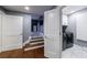 Hallway with hardwood floors transitions into a carpeted area and leads to the laundry room at 5 Coventry Close, Avondale Estates, GA 30002