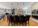 Spacious kitchen featuring a large center island, stainless steel appliances, and elegant pendant lighting at 5 Coventry Close, Avondale Estates, GA 30002