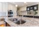 Granite countertops and a stainless sink enhance this stylish kitchen island at 5 Coventry Close, Avondale Estates, GA 30002