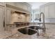 The kitchen's island features granite countertops and stainless steel sink, blending style and functionality at 5 Coventry Close, Avondale Estates, GA 30002