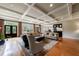 Open-concept living room with hardwood floors, coffered ceilings, and abundant natural light at 5 Coventry Close, Avondale Estates, GA 30002