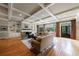 Inviting living room featuring hardwood floors, custom built-ins, a fireplace, and large windows with backyard views at 5 Coventry Close, Avondale Estates, GA 30002