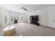 Living room with ceiling fan, carpet, and large windows offering natural light at 5 Coventry Close, Avondale Estates, GA 30002