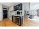 Modern bar with granite countertops and stainless steel appliances adjacent to the living area at 5 Coventry Close, Avondale Estates, GA 30002